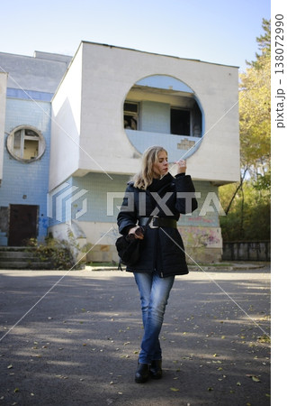A young woman walks through the autumn park. 138072990
