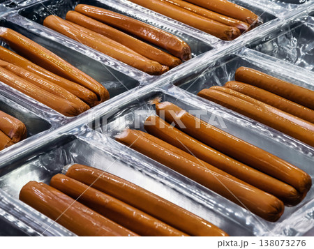 Hot dogs arranged neatly in trays at a food market during the daytime Hot dogs arranged neatly in trays at a food market during the daytime 138073276