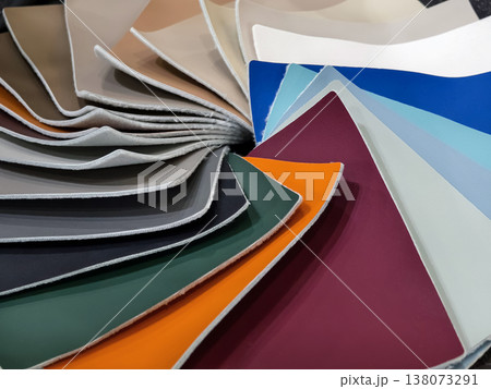 Different colors and textures of fabric samples arranged together at a design studio in the afternoon light Different colors and textures of fabric samples arranged together at a design studio in the afternoon light 138073291