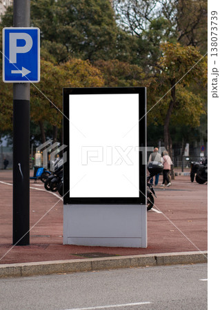 Blank urban billboard mock-up with a white screen for advertising, standing next to a parking sign in a city street scene, offering space for promotional messages Blank urban billboard mock-up with a white screen for advertising, standing next to a parking sign in a city street scene, offering space for promotional messages 138073739