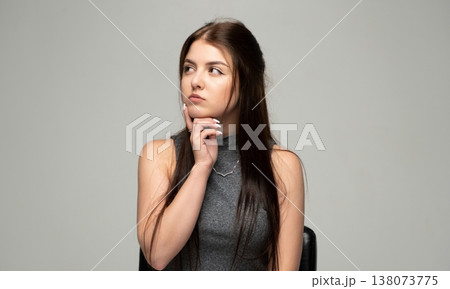 Young woman thinking deeply, contemplating idea, looking away with a pensive expression, feeling indecisive and reflective Young woman thinking deeply, contemplating idea, looking away with a pensive expression, feeling indecisive and reflective 138073775