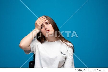 Young woman suffering from headache or migraine, feeling pain, stress, or fever and touching her forehead Young woman suffering from headache or migraine, feeling pain, stress, or fever and touching her forehead 138073797