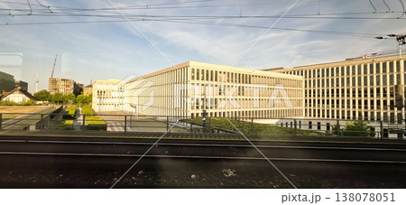 Modern office buildings with green landscape near railway tracks in city Modern office buildings with green landscape near railway tracks in city 138078051