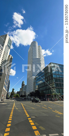 Berlin, Germany - August 18, 2025: Modern skyscraper in urban setting with blue sky 138078090
