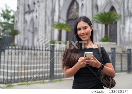 Thai Woman Using Smartphone at St Joseph's Cathedral Hanoi Vietnam Thai Woman Using Smartphone at St Joseph's Cathedral Hanoi Vietnam 138080174