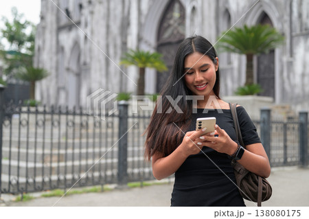 Thai Woman Using Smartphone at St Joseph's Cathedral Hanoi Vietnam Thai Woman Using Smartphone at St Joseph's Cathedral Hanoi Vietnam 138080175