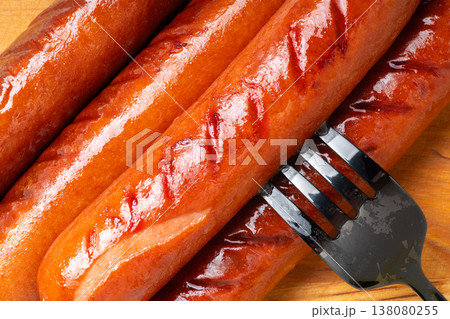 Appetizing grilled sausages on a cutting board close-up Appetizing grilled sausages on a cutting board close-up 138080255
