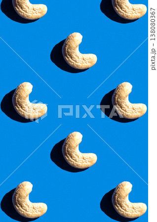 Cashew pattern on blue background, colorful flat lay food texture top view Cashew pattern on blue background, colorful flat lay food texture top view 138080367
