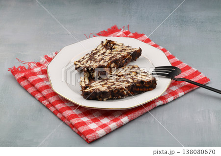 Two Slices of Homemade Chocolate Mosaic Cake with Biscuits on a Plate Two Slices of Homemade Chocolate Mosaic Cake with Biscuits on a Plate 138080670