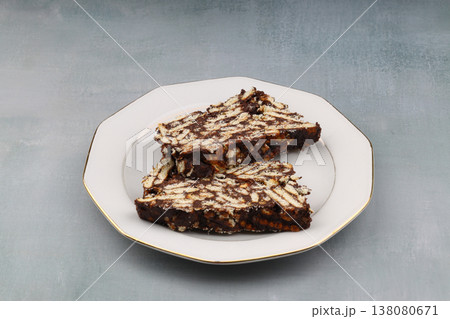 Two Slices of Homemade Chocolate Mosaic Cake with Biscuits on a Plate Two Slices of Homemade Chocolate Mosaic Cake with Biscuits on a Plate 138080671