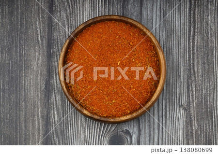 Cajun seasoning in a bowl on a dark wooden background Cajun seasoning in a bowl on a dark wooden background 138080699