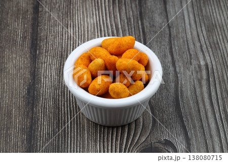 Crunchy Coated Peanuts in a Wooden Bowl on Wooden Background Crunchy Coated Peanuts in a Wooden Bowl on Wooden Background 138080715