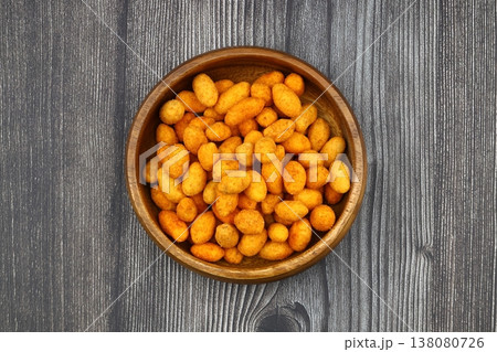 Crunchy Coated Peanuts in a Wooden Bowl on Wooden Background Crunchy Coated Peanuts in a Wooden Bowl on Wooden Background 138080726