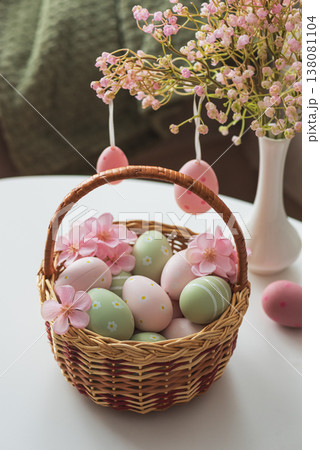 Easter Basket with Ester Eggs,  Plush Bunny and Spring Decor on White Table intoCozy Living Room 138081104