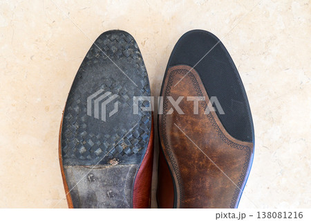 A new boot next to an old worn one, comparison of men's leather shoes A new boot next to an old worn one, comparison of men's leather shoes 138081216
