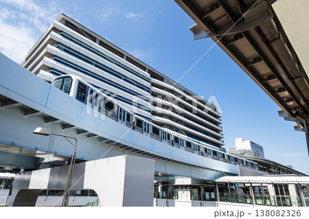 View of a New Transit Yurikamome line train running on the elevated track, driving past the Shijo mae Station in Koto, Tokyo, Japan. It's an automated guideway transit service in Tokyo. 138082326