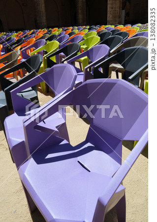 rows of colorful plastic chairs and an open-air auditorium rows of colorful plastic chairs and an open-air auditorium 138082335