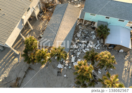 Storm surge severe damage to residential houses on ocean shore after hurricane landfall. Natural disaster consequences in Florida Storm surge severe damage to residential houses on ocean shore after hurricane landfall. Natural disaster consequences in Florida 138082567