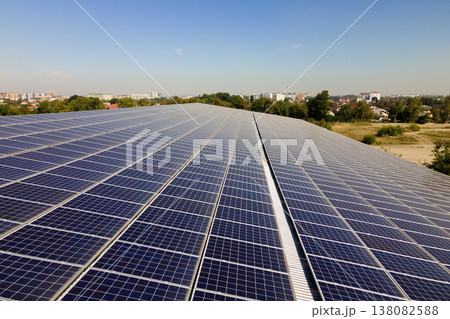 Solar photovoltaic panels installed on building roof for producing clean ecological electric energy. Renewable electricity with zero emission concept Solar photovoltaic panels installed on building roof for producing clean ecological electric energy. Renewable electricity with zero emission concept 138082588
