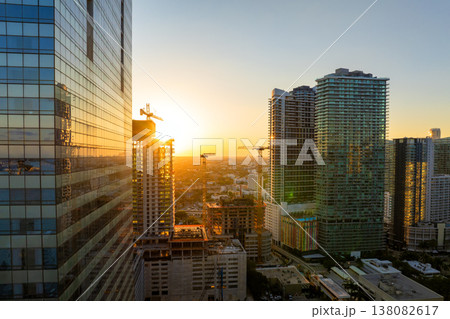 Skyscraper construction in Miami, Florida at sunset. USA real estate development. Big city urban landscape with high-rise buildings Skyscraper construction in Miami, Florida at sunset. USA real estate development. Big city urban landscape with high-rise buildings 138082617