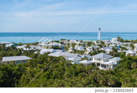 Rich neighborhood with expensive vacation homes and white lighthouse on ocean shore in Boca Grande, small town on Gasparilla Island in southwest Florida. Wealthy waterfront residential area 138082663