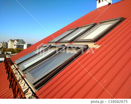 Red tiled house roof with attic windows. Roofing construction, window installation, modern architecture concept. 138082675