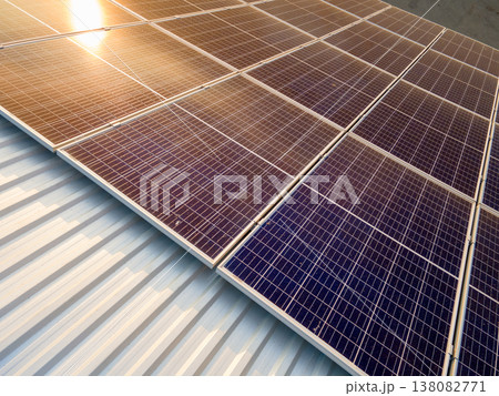 Office building with solar roof. Blue photovoltaic panels for producing clean ecological electric energy. Investing in renewable electricity concept. 138082771
