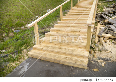 New wooden stairs outdoors. Carpenters work. New wooden stairs outdoors. Carpenters work. 138082773