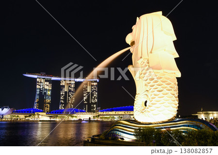 Night view of the Merlion with the background of Marina Bay Sands buildings in Singapore. Merlion is the official mascot of Singapore. Night view of the Merlion with the background of Marina Bay Sands buildings in Singapore. Merlion is the official mascot of Singapore. 138082857