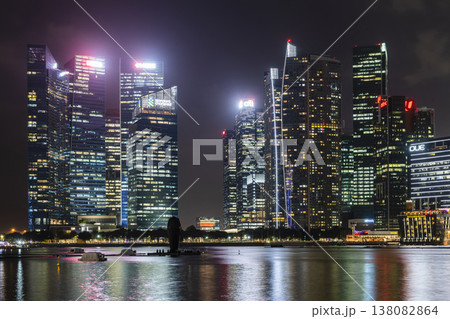 Night view of the Marina Bay Financial Centre and the Raffles Place modern office skyscrapers along Marina Bay in Singapore.  138082864