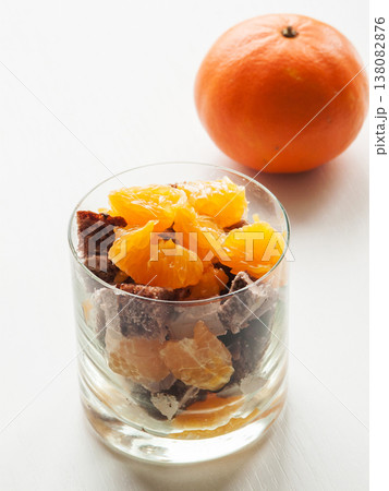 Glass with fresh oranges and chocolate cake dessert parfait, sweet snacks with fruits. Glass with fresh oranges and chocolate cake dessert parfait, sweet snacks with fruits. 138082876