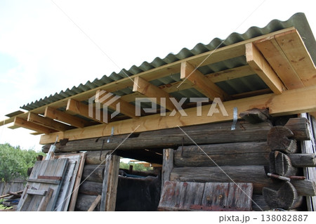 Wooden beam framework with galvanized metal connectors and corrugated roof covering, residential construction detail Wooden beam framework with galvanized metal connectors and corrugated roof covering, residential construction detail 138082887