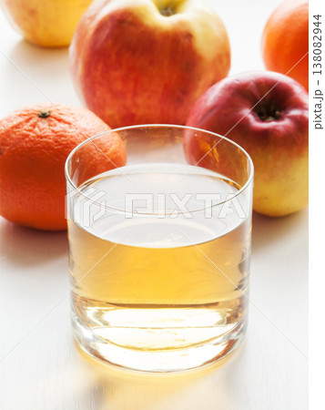 Glass of fresh apple and orange mixed vitamin juice on table with fruits, sweet healthy beverage. 138082944