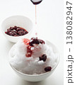 Shaved ice Kakigori granita berry dessert for summer made of ice with juice sauce in bowl on table. 138082947