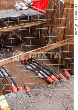 black plastic pipes in ground for drainage of sewage rainwater, lying in trench of sand. black plastic pipes in ground for drainage of sewage rainwater, lying in trench of sand. 138083013