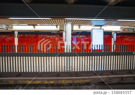 Curved subway tracks run through the Bowling Green station platform in Manhattan, New York City. Red tiled walls and structural columns frame the underground public transportation system. Curved subway tracks run through the Bowling Green station platform in Manhattan, New York City. Red tiled walls and structural columns frame the underground public transportation system. 138083357