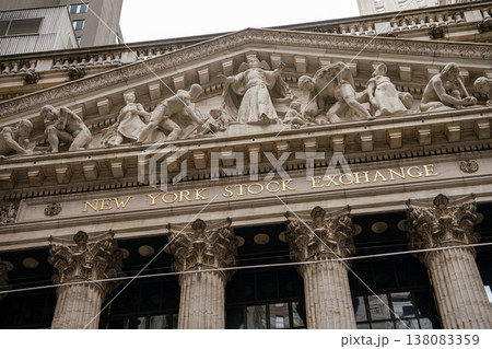 Close view of the New York Stock Exchange sign beneath its sculpted pediment on Wall Street. Classical stone relief figures represent commerce and industry in Manhattan financial district. 138083359