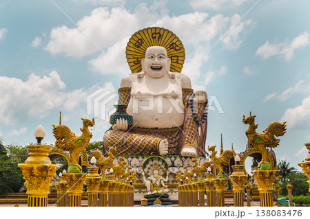 Giant laughing buddha statue at plai laem temple koh samui thailand with ornate golden sculptures and decorative pillars 138083476