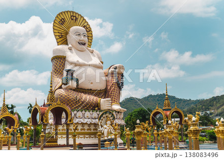 Giant laughing buddha statue at plai laem temple koh samui thailand with ornate golden architecture and tropical landscape 138083496
