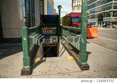 Green subway entrance with stairs leading underground at Broadway Lafayette station in Manhattan. New York City public transportation access at street level. 138083532