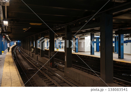 Curved railway tracks at Broadway Lafayette Street subway station in Manhattan. Underground New York City metro platform with yellow safety strip, steel columns, and urban transit infrastructure. 138083541