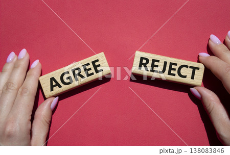 Agree or Reject symbol. Concept word Agree or Reject on wooden blocks. Businessman hand. Beautiful red background. Gender and Agree or Reject concept. Copy space 138083846