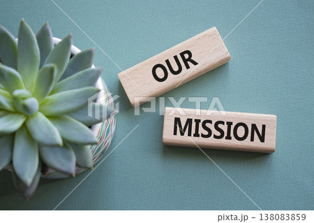 Our Mission symbol. Concept word Our Mission on wooden blocks. Beautiful grey green background with succulent plant. Business and Our Mission concept. Copy space Our Mission symbol. Concept word Our Mission on wooden blocks. Beautiful grey green background with succulent plant. Business and Our Mission concept. Copy space 138083859
