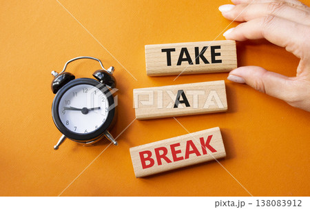 Take a break symbol. Concept words Take a break on wooden blocks. Businessman hand. Beautiful orange background with alarm clock. Business and Take a break concept. Copy space. Take a break symbol. Concept words Take a break on wooden blocks. Businessman hand. Beautiful orange background with alarm clock. Business and Take a break concept. Copy space. 138083912