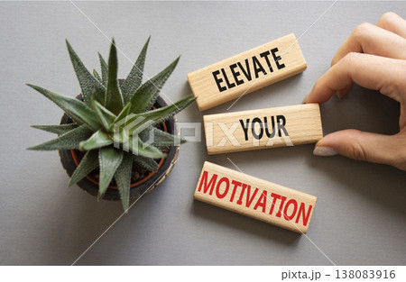 Motivation symbol. Wooden blocks with words Elevate your Motivation. Beautiful grey background with succulent plant. Businessman hand. Business and Elevate your Motivation concept. Copy space. Motivation symbol. Wooden blocks with words Elevate your Motivation. Beautiful grey background with succulent plant. Businessman hand. Business and Elevate your Motivation concept. Copy space. 138083916