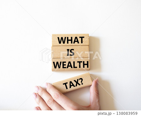 Tax symbol. Concept words What is Wealth Tax on wooden blocks. Beautiful bright white background. Businessman hand. Business and What is Wealth Tax concept. Copy space. Tax symbol. Concept words What is Wealth Tax on wooden blocks. Beautiful bright white background. Businessman hand. Business and What is Wealth Tax concept. Copy space. 138083959