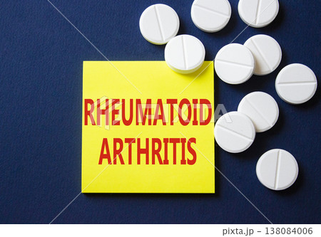 Rheumatoid Arthritis symbol. Concept word Rheumatoid Arthritis on yellow note. Beautiful deep blue background with pills. Medicine and Rheumatoid Arthritis concept. Copy space Rheumatoid Arthritis symbol. Concept word Rheumatoid Arthritis on yellow note. Beautiful deep blue background with pills. Medicine and Rheumatoid Arthritis concept. Copy space 138084006