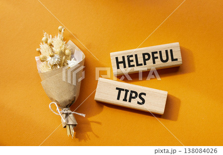 Helpful tips symbol. Wooden blocks with words Helpful tips. Beautiful orange background with bouquet of flowers. Business and Helpful tips concept. Copy space. Helpful tips symbol. Wooden blocks with words Helpful tips. Beautiful orange background with bouquet of flowers. Business and Helpful tips concept. Copy space. 138084026