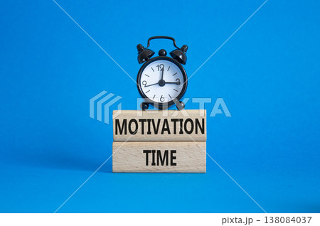 Motivation Time symbol. Concept word Motivation Time on wooden blocks. Beautiful blue background with alarm clock. Business and Motivation Time concept. Copy space Motivation Time symbol. Concept word Motivation Time on wooden blocks. Beautiful blue background with alarm clock. Business and Motivation Time concept. Copy space 138084037