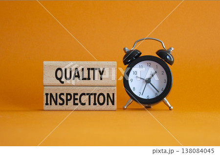 Quality Inspection symbol. Concept word Quality Inspection on wooden blocks. Beautiful orange background with alarm clock. Business and Quality Inspection concept. Copy space Quality Inspection symbol. Concept word Quality Inspection on wooden blocks. Beautiful orange background with alarm clock. Business and Quality Inspection concept. Copy space 138084045